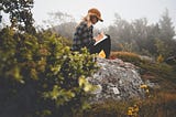 a writer writing in a notebook in nature