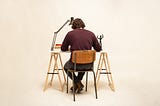 Man writing at a desk