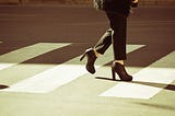 Close up of a woman in heels on a zebra crossing