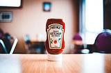 A bottle of Heinz ketchup on a table