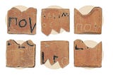 Six rectangular clay plates cut with a serrated edge, in some of them an inscription in Greek can be sensed.