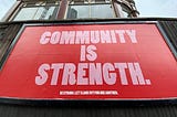 A poster depicting that community is strength