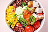 round bowl containing rainbow of foods