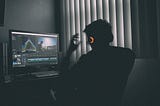 Man working on computer using Premiere Pro