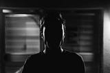frward facing head potrait of a person but shadowed our face, very dark grim ambiance.