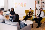 A group of professionals sitting together and having a discussion.