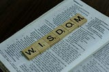 the word “WISDOM” on a sheet of paper.