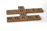 Scrabble tiles that read “Choose your words.”
