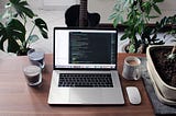 Developer’s desk with IDE open on Macbook Pro
