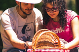 Husband and wife opening a picnic basket