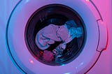 Multicolored clothing visible through the clear front of a white laundry machine.