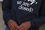 A picture of a T-shirt worn by someone and it has the writings “sorry we are closed,” used to signify someone who has chosen to limit unwanted access.