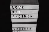 A digital sign bearing the words “Love one another”.