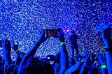 The image is of a concert, but represents the poet in a place where he is surrounded by the world, yet lost in his mind