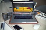 Landing page with a yellow sofa on Macbook