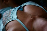 A woman’s breasts in light blue lingerie.