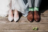 bride and groom showing their shoes