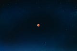 Red moon in darkness of universe