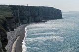 Massive cliffs tower over the Beaches of Normandy and the English Channel.