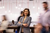 Woman smiling in office with blurry background
