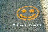 Smile face with the words stay safe