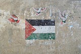 Palestinian flag on a wall surrounded by three doves