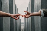 couple reaching out to hold hands.