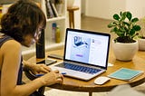 Woman typing on a a laptop.