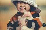 Child holding stuffy animal