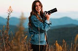 Photo by Jake Johnson on Unsplash of a woman holding a camera
