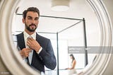 https://media.gettyimages.com/photos/mirror-reflection-of-young-businessman-adjusting-shirt-and-tie-in-picture-id661783725?s=