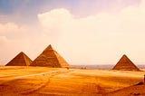 Giza Necropolis seen from far away symbolizing the sweet results at the end of a long doubtful road.