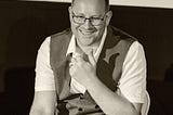 A photo of Kieran Rose, The Autistic Advocate, wearing a waistcoat and glasses