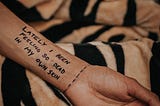 A hand with text written as: LATELY I BEEN FEELING SO DEAD IN MY OWN SKIN