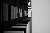 An abstract-ish photo. It looks like it’s a shot of a building taken from the ground, looking up. The building fills two thirds of the frame, and then sky fills the next third.