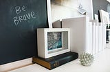 The words “Be Brave” on a chalk board.