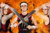 A young man in glasses and a white headband carrying two machetes in crossed with each other on a background of fire. A picture of him turned to the side and posing with the machete is superimposed on either side of the pic.