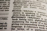 An English to English dictionary with the word “dictionary” in focus