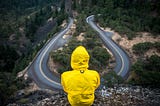 Person overlooking a crossroads on a mountain top