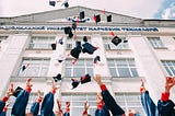 University students on graduation day throwing their caps in the sky