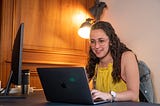 A woman coding on her laptop.