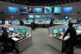 Main Control Room at ESA’s Space Operation Centre: so basically a lot of monitors displaying multiple measurements and people watching them carefully during a mission.