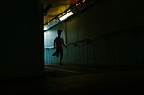 boy running down a shadowy hallway