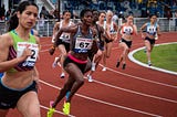 Side view of athletes running on the track