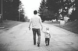 Being a dad at 46 — Dad and son walking on the street