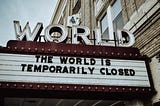 An old cinema listings board that reads “the world is currently closed”