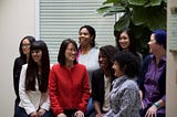 Image of the eight cofounders of Project Include (listed below) sitting casually in a group, smiling and looking at each other or at another camera