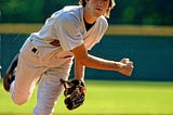 Little league pitcher focused on striking out his enemy.