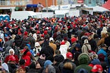 Large crowd of people fill a town square