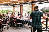 A person speaking to a group of people